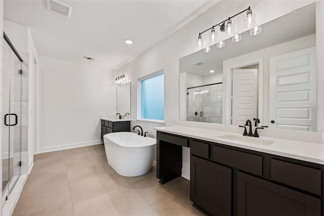 full bath with a stall shower, tile patterned flooring, visible vents, and a sink