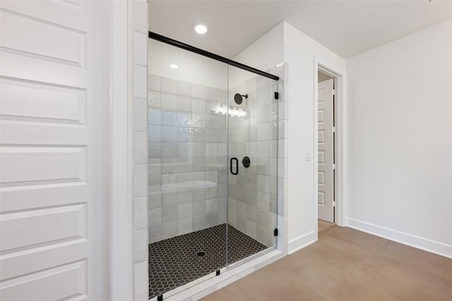 full bath featuring recessed lighting, a shower stall, and baseboards