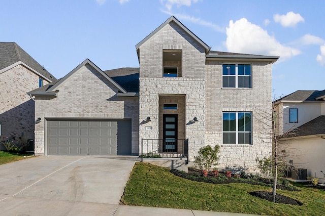 view of front facade with a garage, central AC unit, and a front yard