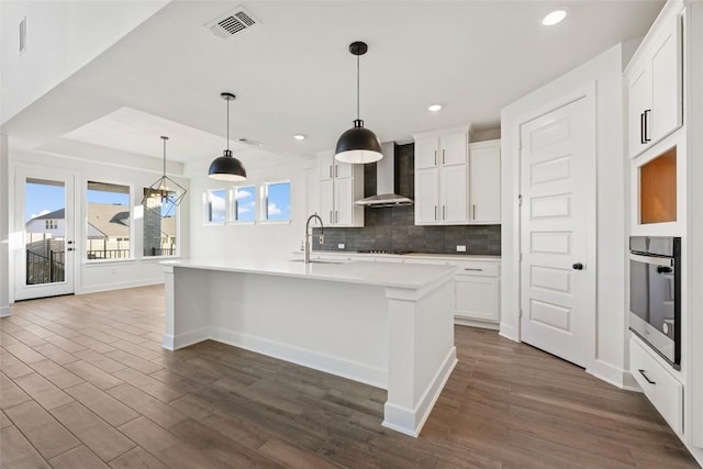 1205 Summer Moon Dr, Georgetown, TX 78628 - kitchen featuring stainless steel oven, a sink, wall chimney range hood, dark wood-type flooring, and backsplash