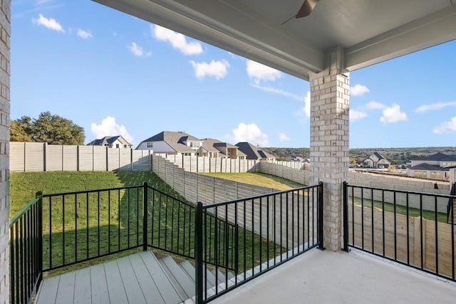 balcony featuring a ceiling fan and a residential view