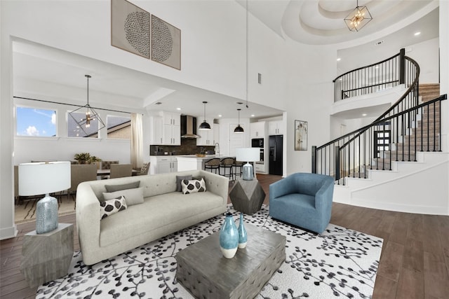 1205 Summer Moon Dr, Georgetown, TX 78628 - living room with a chandelier, stairway, wood finished floors, recessed lighting, and baseboards