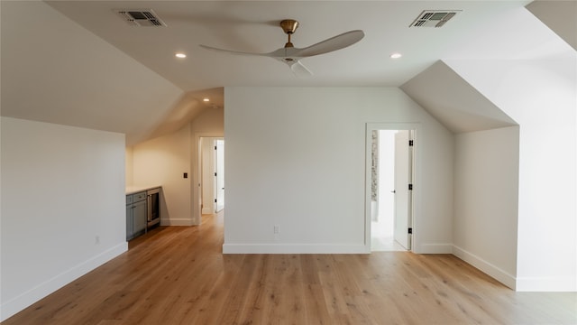 additional living space with light wood-type flooring, vaulted ceiling, and ceiling fan