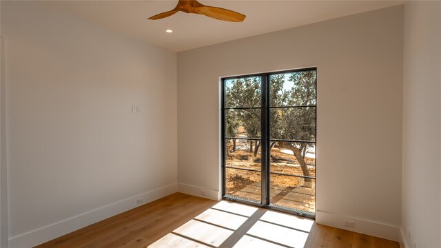 empty room featuring ceiling fan and light hardwood / wood-style flooring