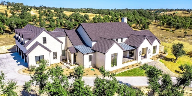 birds eye view of property with a forest view