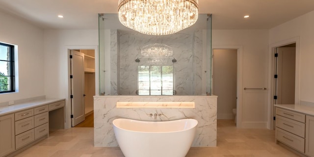 full bathroom with recessed lighting, a freestanding bath, toilet, and an inviting chandelier