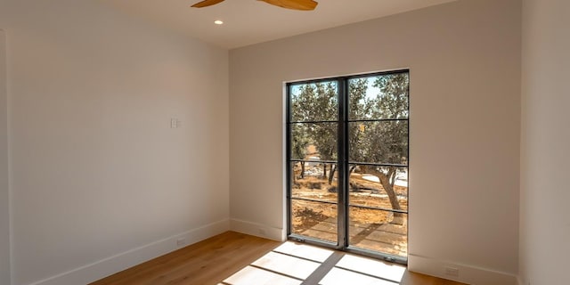 spare room with light wood-style flooring, baseboards, ceiling fan, and recessed lighting