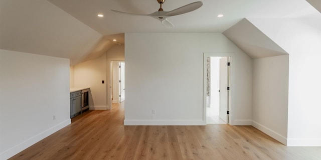 additional living space featuring light wood-type flooring, vaulted ceiling, a ceiling fan, and recessed lighting