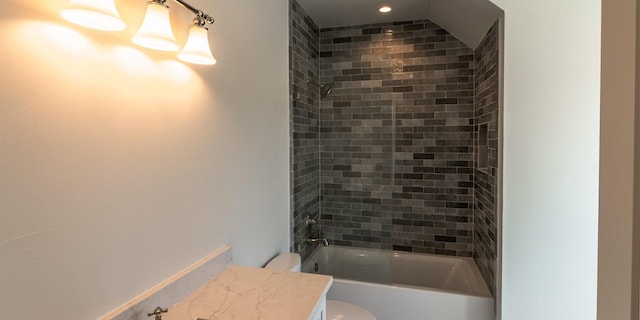 bathroom featuring toilet, shower / washtub combination, and vanity