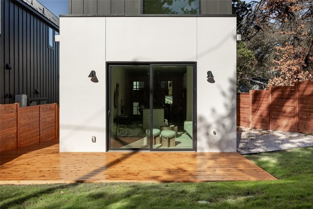 view of exterior entry with a wooden deck