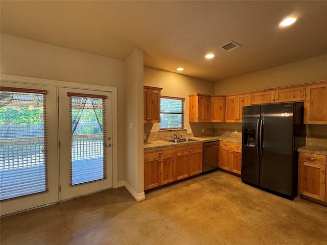 kitchen with refrigerator with ice dispenser, a wealth of natural light, dishwasher, and sink