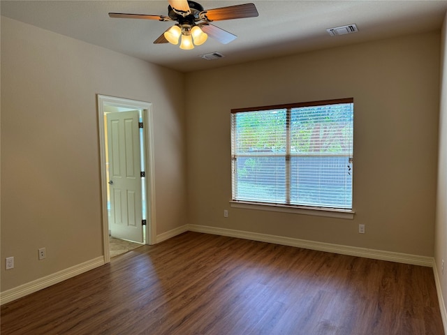 spare room featuring ceiling fan and dark hardwood / wood-style floors