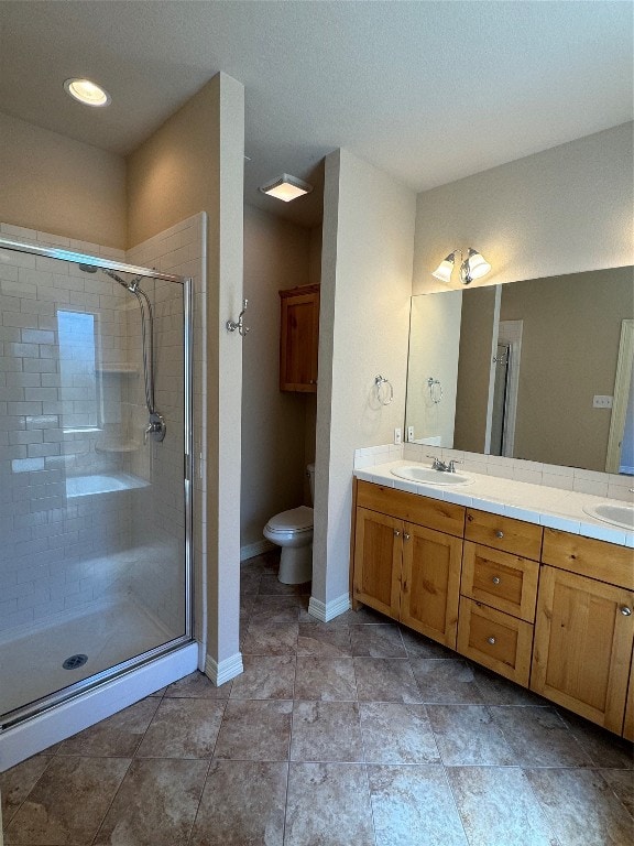 bathroom with vanity, toilet, and a shower with shower door