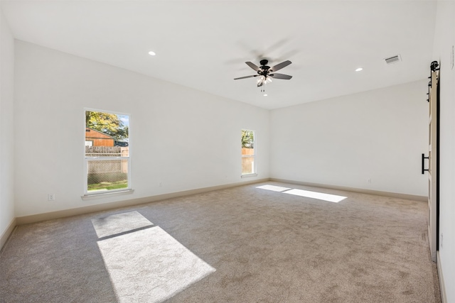 spare room with light carpet and ceiling fan