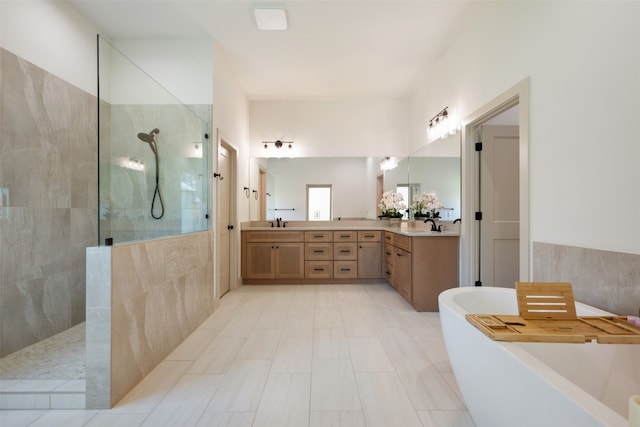 bathroom featuring vanity, shower with separate bathtub, and tile walls