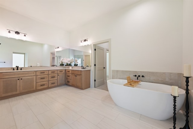 bathroom with tile patterned flooring, vanity, and a tub to relax in