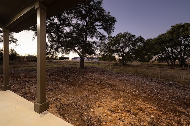 view of yard at dusk