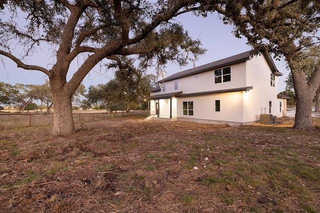 back of property featuring central AC