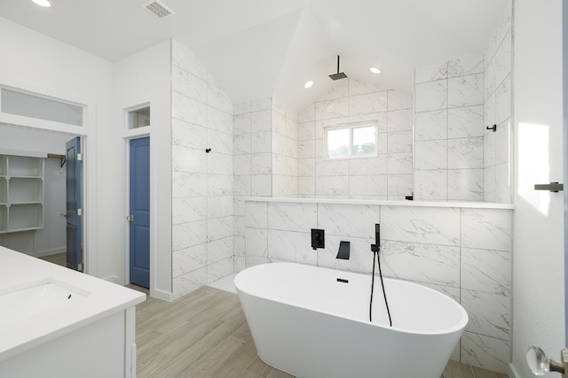 bathroom with vanity, separate shower and tub, wood-type flooring, and tile walls