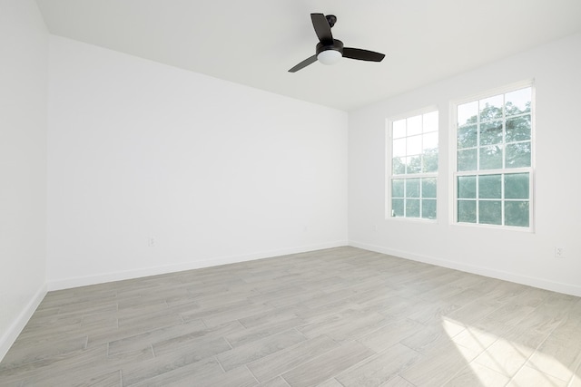 unfurnished room with ceiling fan and light wood-type flooring