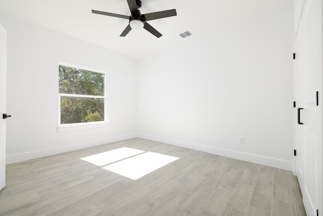 empty room featuring ceiling fan and light wood-type flooring