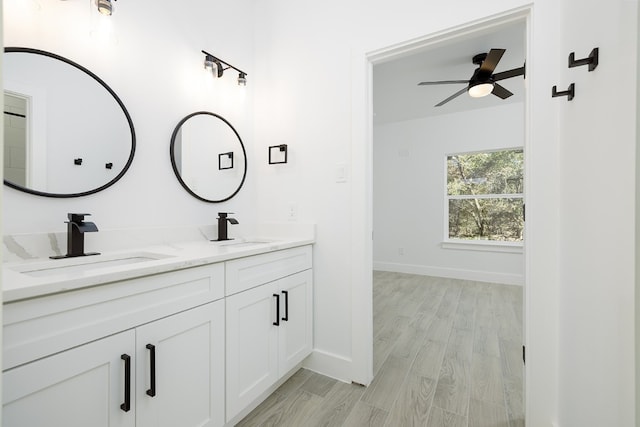 bathroom with hardwood / wood-style floors, vanity, and ceiling fan