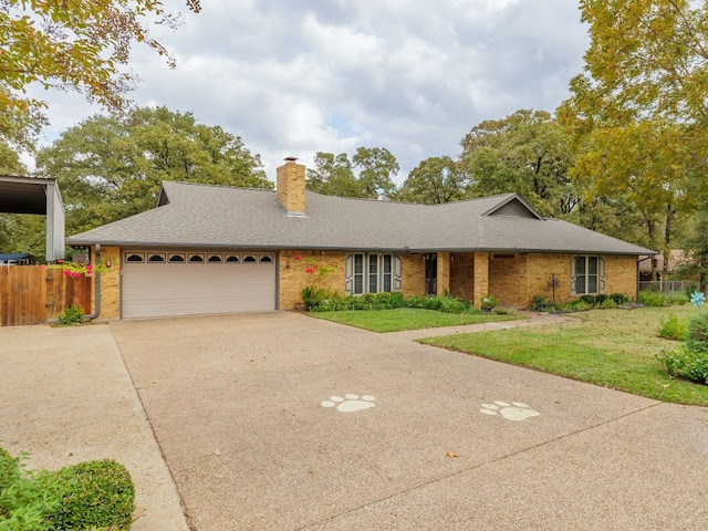 single story home featuring a garage and a front yard