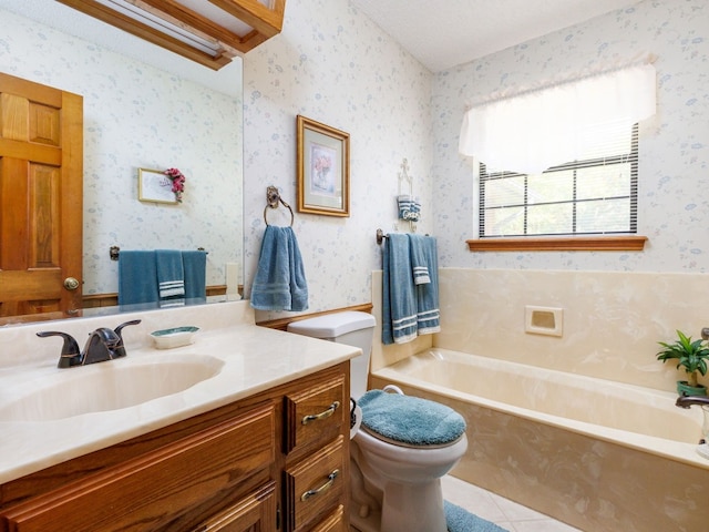 bathroom with tile patterned flooring, vanity, toilet, and a tub to relax in