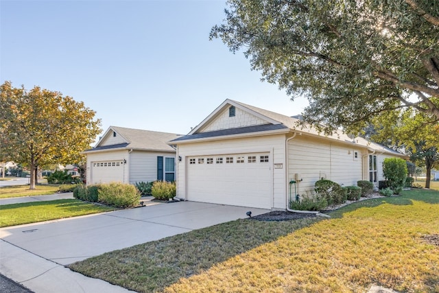 ranch-style home with a garage and a front lawn