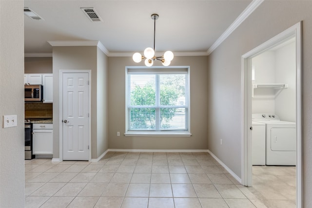 unfurnished dining area with ornamental molding, washer and clothes dryer, a notable chandelier, and light tile patterned flooring