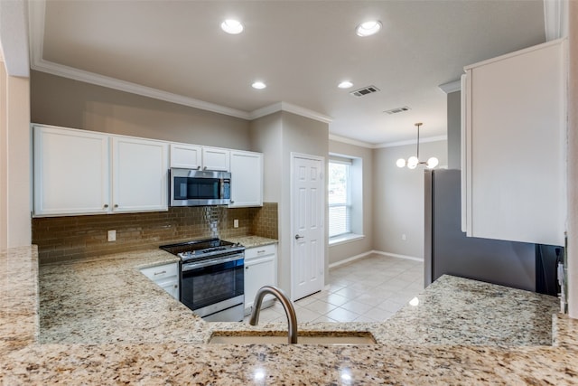 kitchen with sink, hanging light fixtures, a chandelier, white cabinets, and appliances with stainless steel finishes