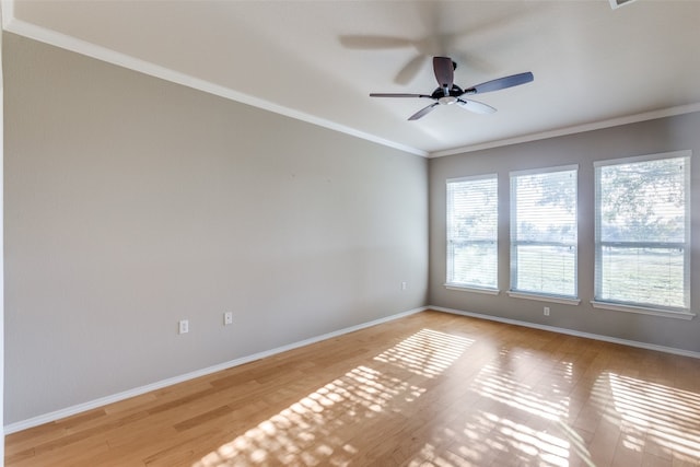 empty room featuring ceiling fan, light wood-type flooring, and ornamental molding