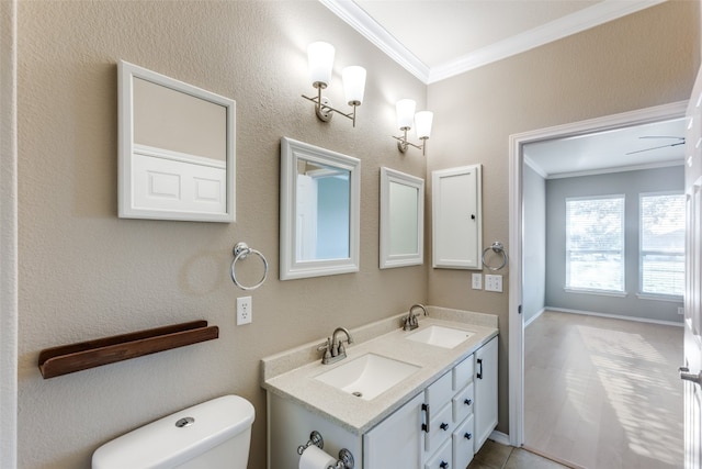 bathroom with toilet, vanity, and ornamental molding