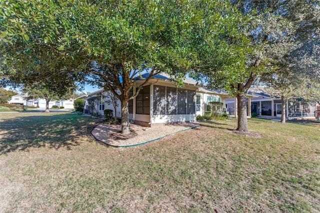 ranch-style home featuring a front yard and a sunroom