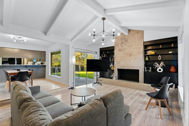 living room with lofted ceiling with beams, built in shelves, light wood-type flooring, a fireplace, and a chandelier