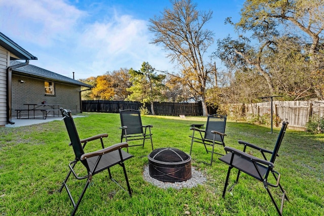 view of yard with an outdoor fire pit