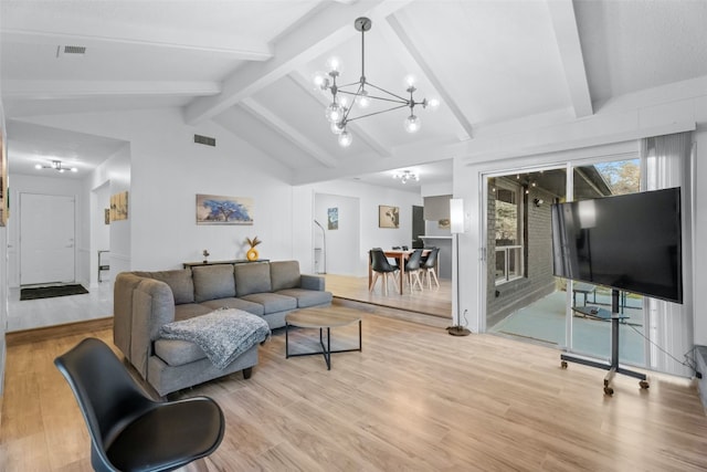 living room featuring lofted ceiling with beams, light hardwood / wood-style flooring, and a notable chandelier