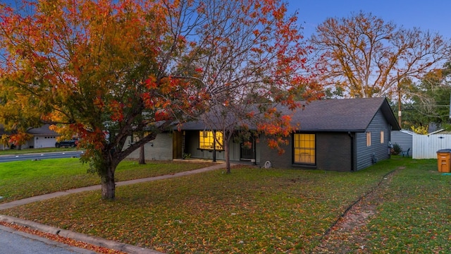 obstructed view of property with a front yard