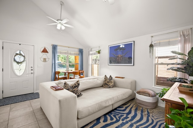 tiled living room featuring ceiling fan and high vaulted ceiling