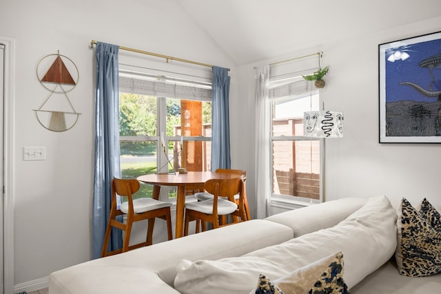 dining room with plenty of natural light and lofted ceiling