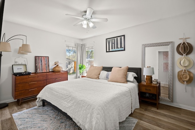 bedroom with ceiling fan and dark wood-type flooring