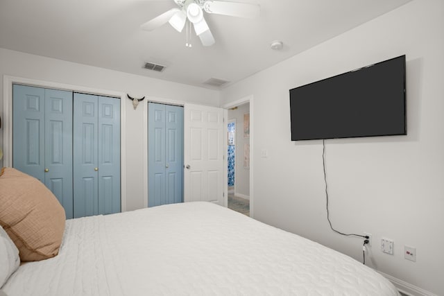 bedroom featuring ceiling fan and multiple closets