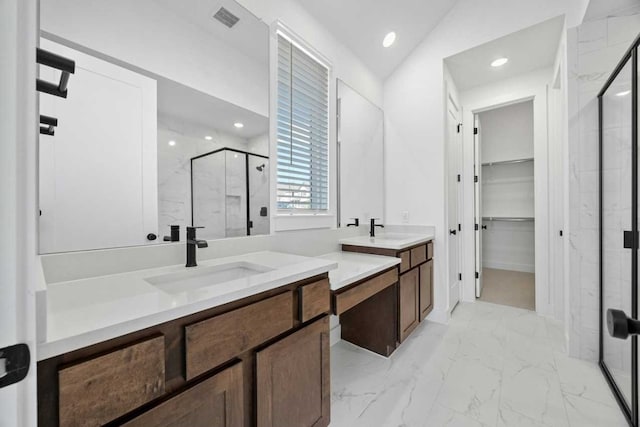 bathroom with lofted ceiling, a shower with shower door, and vanity