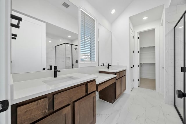 bathroom with vaulted ceiling, vanity, and a shower with door