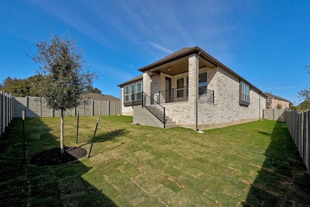 rear view of house with a yard