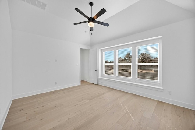 spare room with ceiling fan, lofted ceiling, and light hardwood / wood-style floors