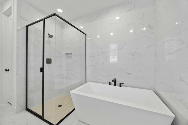 bathroom featuring separate shower and tub