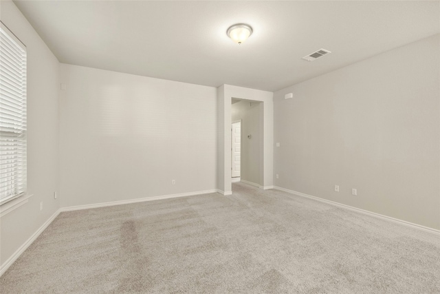 unfurnished room featuring light colored carpet