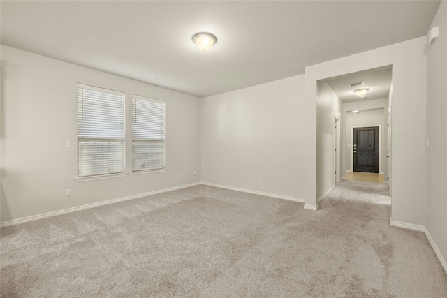 spare room with light colored carpet