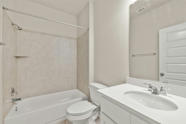 full bathroom with vanity, tiled shower / bath combo, and toilet